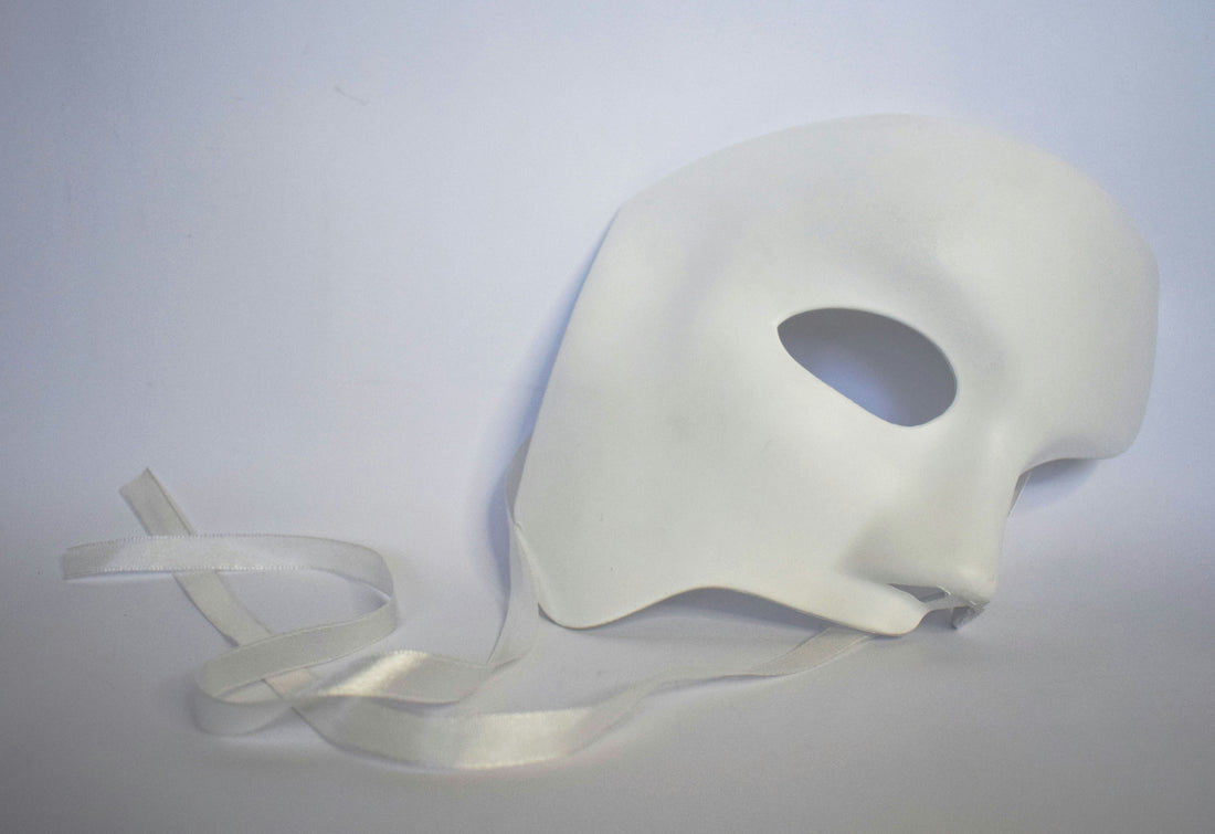 White mask on light backdrop, illustrating masking in neurodiversity – Bright Balance Studio blog