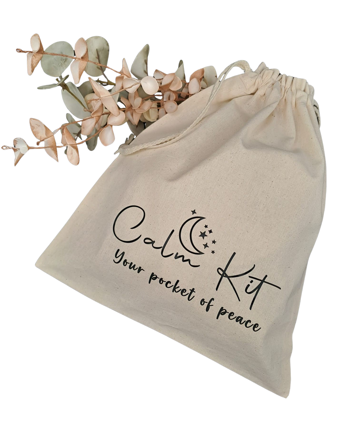 Calm Kit flat lay with soft natural light, showing calming objects and a beige cotton pouch.